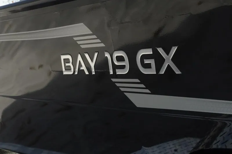 Slide: The Image of 2026 G3 Bay 19 GX boat model name on sleek black surface. - 28
