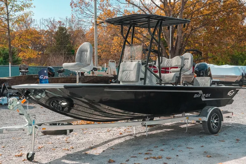 Slide: The Image of 2026 G3 Bay 19 GX boat on trailer, parked outdoors in autumn setting. - 5