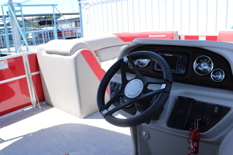 Slide: The Image of 2024 Berkshire 24RFX LE boat interior with steering wheel and dashboard controls. - 9