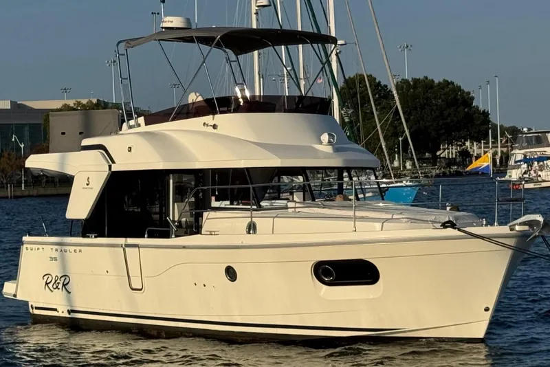 The Image of 2023 Beneteau Swift Trawler 35 yacht docked in a marina, side view. - 0