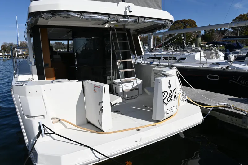 Slide: The Image of 2023 Beneteau Swift Trawler 35 docked at marina, rear view. - 11