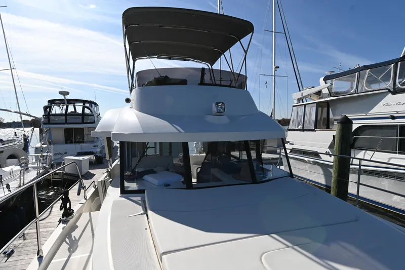 Slide: The Image of 2023 Beneteau Swift Trawler 35 docked at marina under clear blue sky. - 14