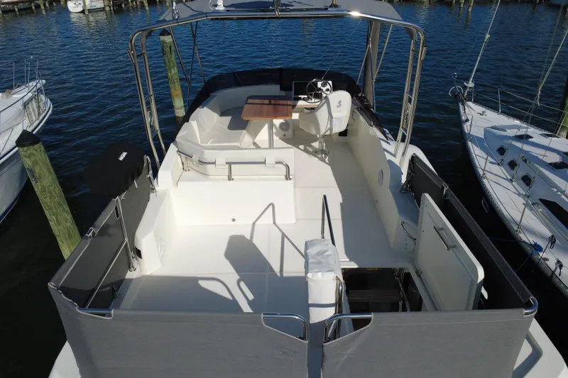 Slide: The Image of 2023 Beneteau Swift Trawler 35, spacious deck view, docked at marina. - 17