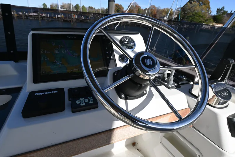 Slide: The Image of Helm of 2023 Beneteau Swift Trawler 35 with navigation equipment and steering wheel. - 25