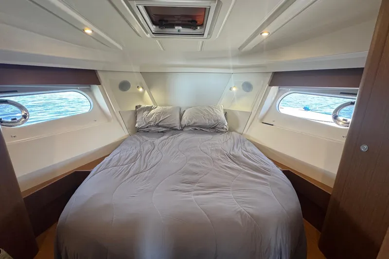 Slide: The Image of Luxurious cabin interior of 2023 Beneteau Swift Trawler 35 with cozy bed and porthole views. - 45