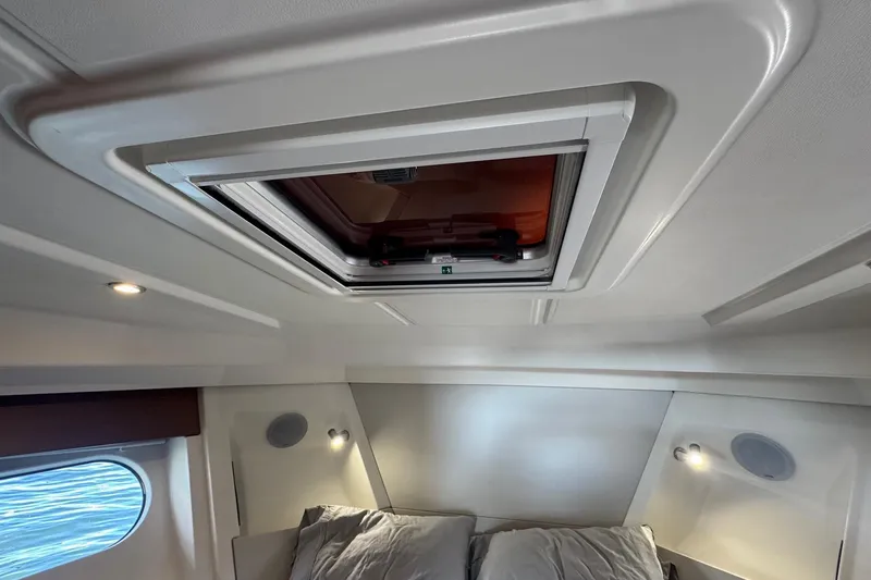 Slide: The Image of 2023 Beneteau Swift Trawler 35 cabin interior with skylight and modern lighting. - 49