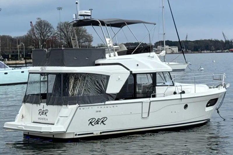 Slide: The Image of 2023 Beneteau Swift Trawler 35 yacht on calm water, side view. - 60