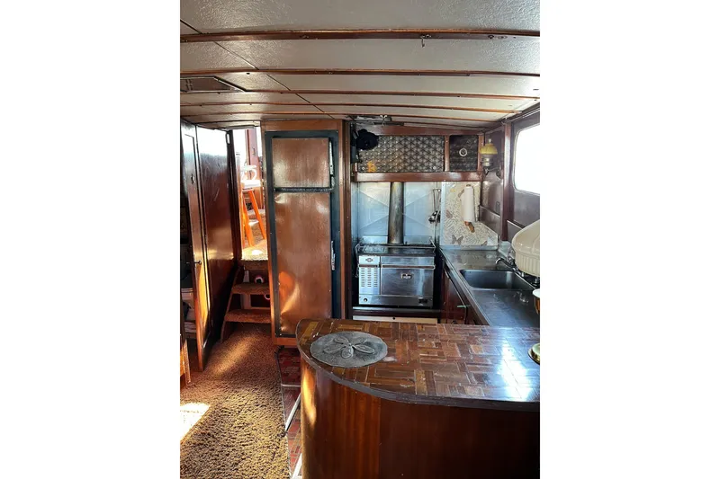 Slide: The Image of Interior of 1943 Shain-Monk 50 Twin Engine Classic Bridgedeck Cruiser with vintage kitchen setup. - 11