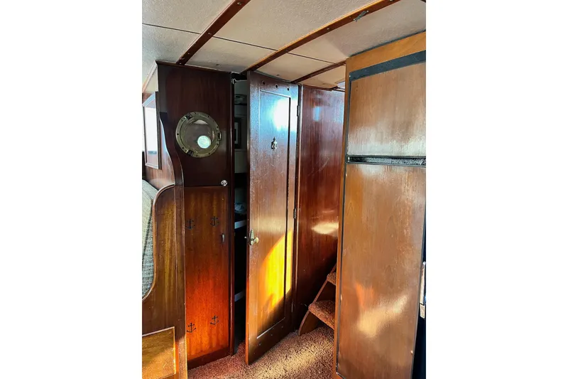 Slide: The Image of Interior of 1943 Shain-Monk 50 Twin Engine Cruiser with wooden cabinetry and porthole. - 12