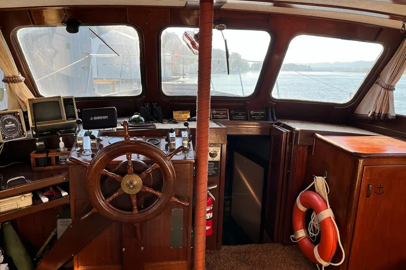 Slide: The Image of 1943 Shain-Monk 50 Twin Engine Classic Bridgedeck Cruiser interior with wooden helm and navigation equipment. - 2