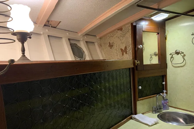 Slide: The Image of Interior of 1943 Shain-Monk cruiser bathroom with vintage decor and porthole window. - 22