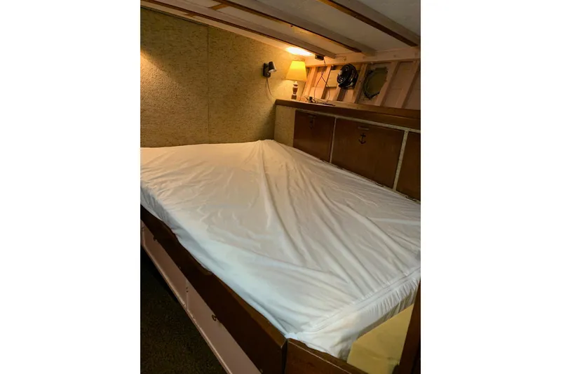 Slide: The Image of Cozy cabin interior of 1943 Shain-Monk cruiser with bed and warm lighting. - 24