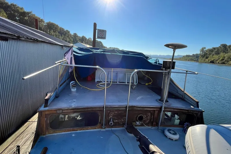 Slide: The Image of 1943 Shain-Monk 50 Twin Engine Classic Bridgedeck Cruiser docked by a serene river. - 27