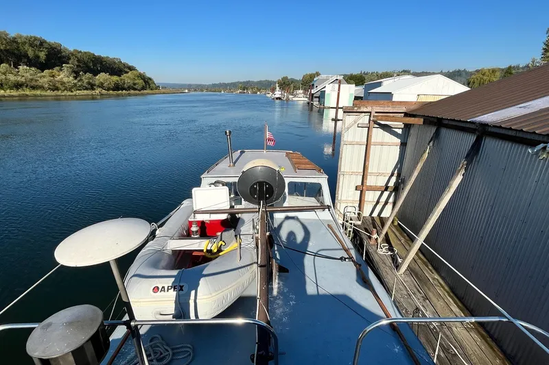 Slide: The Image of 1943 Shain-Monk 50 Twin Engine Classic Bridgedeck Cruiser docked on a serene river. - 28