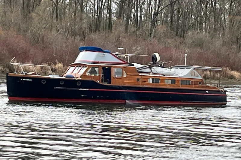 Slide: The Image of Vintage 1943 Shain-Monk Bridgedeck Cruiser on a serene river. - 29