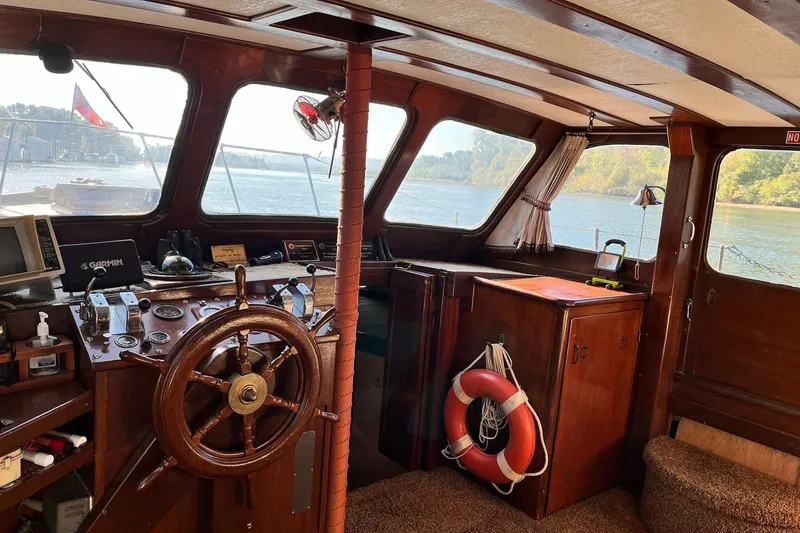 Slide: The Image of Interior of 1943 Shain-Monk 50 Twin Engine Classic Bridgedeck Cruiser with wooden helm and river view. - 3