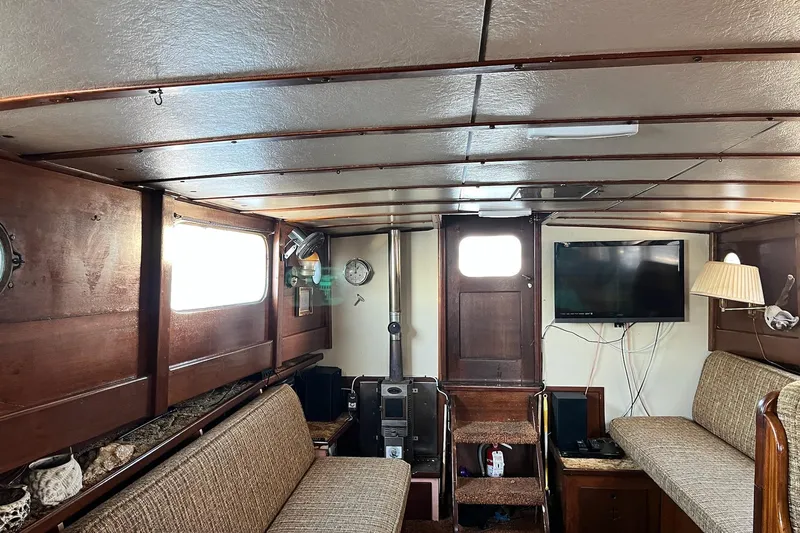 Slide: The Image of Interior of 1943 Shain-Monk cruiser with wood paneling, seating, and a wall-mounted TV. - 4