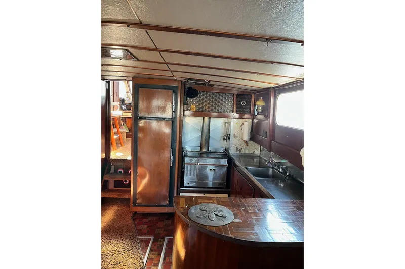 Slide: The Image of Interior of 1943 Shain-Monk 50 Twin Engine Classic Bridgedeck Cruiser, featuring vintage kitchen design. - 9