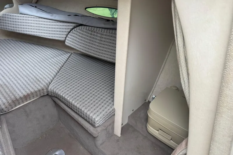 Slide: The Image of Interior cabin of 2004 Sea Ray 215 Weekender with cushioned seating and portable toilet. - 14