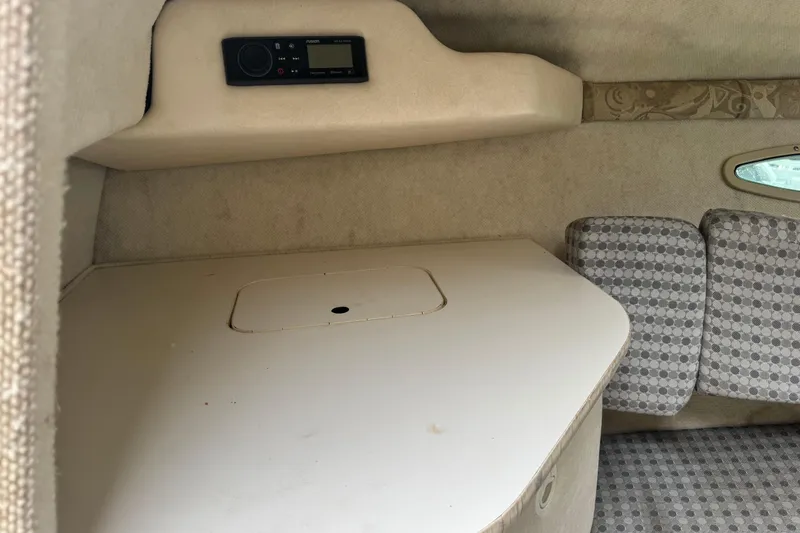 Slide: The Image of 2004 Sea Ray 215 Weekender cabin interior with seating and control panel. - 16