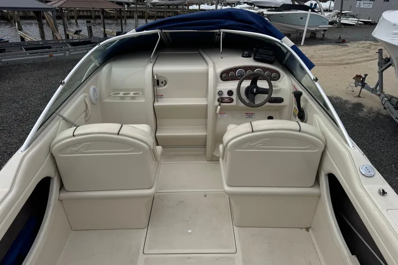 Slide: The Image of 2004 Sea Ray 215 Weekender boat interior with steering wheel and seating. - 18