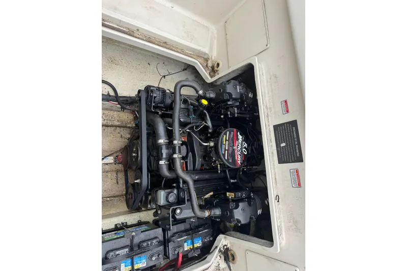 Slide: The Image of Engine compartment of a 2004 Sea Ray 215 Weekender boat, featuring a Mercury 5.0 engine. - 19