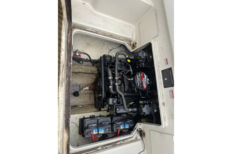 Slide: The Image of Engine compartment of a 2004 Sea Ray 215 Weekender boat, showcasing the motor and components. - 20