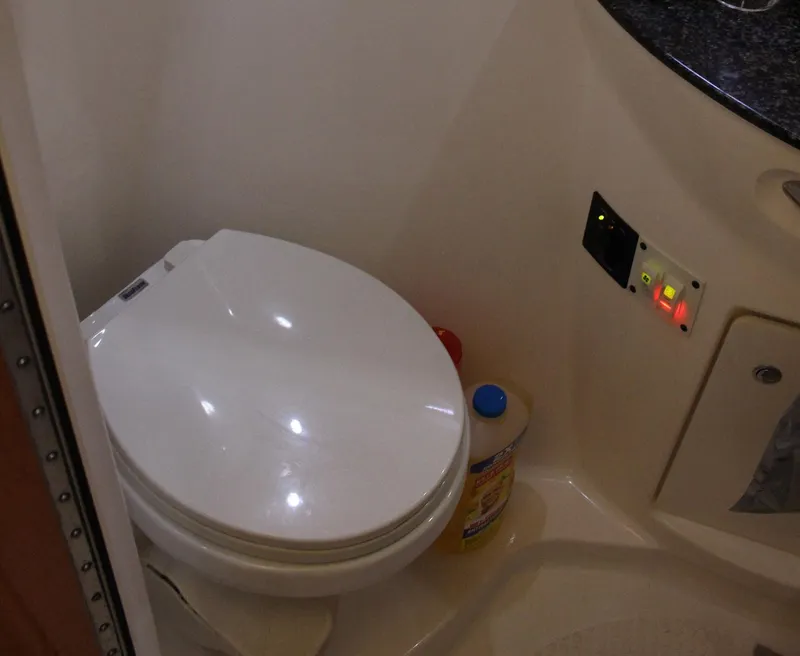 Slide: The Image of 2008 Chaparral 350 Signature boat bathroom with toilet and cleaning supplies. - 39