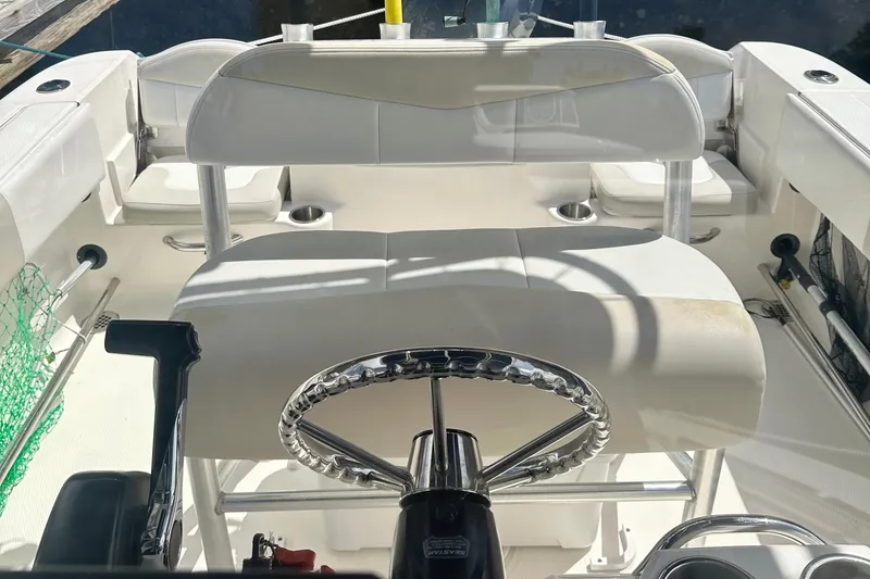 Slide: The Image of 2015 Robalo R200 Center Console boat interior with steering wheel and seating. - 10