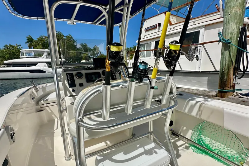 Slide: The Image of 2015 Robalo R200 Center Console boat with fishing rods and blue canopy. - 12