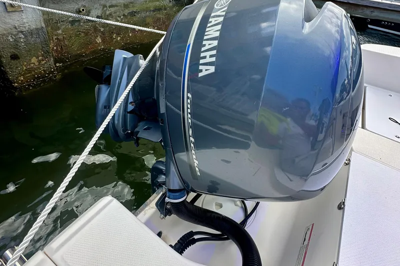 Slide: The Image of 2015 Robalo R200 Center Console with Yamaha outboard motor docked by water. - 15