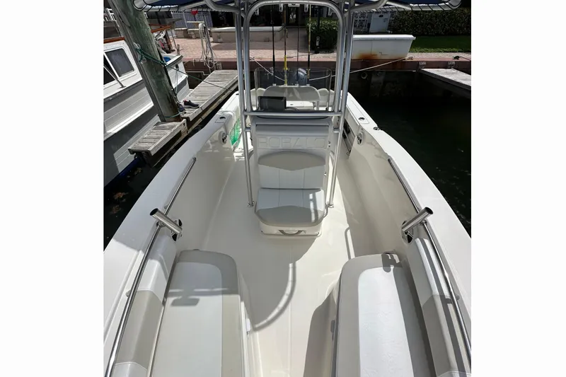 Slide: The Image of 2015 Robalo R200 Center Console boat docked, featuring spacious seating and sleek design. - 4