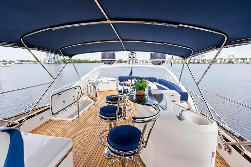 Slide: The Image of Luxurious 2006 Sunseeker 75 Yacht deck with bar stools and city skyline view. - 38