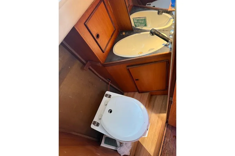 Slide: The Image of 1985 Jouet 950 boat bathroom with wooden cabinets and white fixtures. - 10