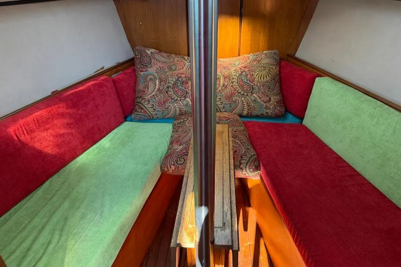 Slide: The Image of Cozy interior of 1985 Jouet 950 sailboat with colorful cushions and wooden accents. - 7