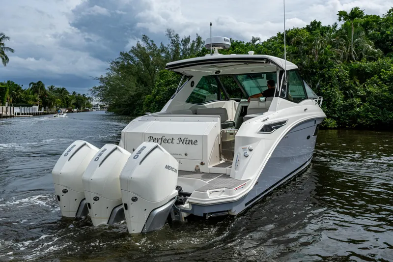 Slide: The Image of 2023 Sea Ray Sundancer 320 Outboard cruising on a scenic waterway. - 2