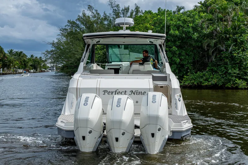 Slide: The Image of 2023 Sea Ray Sundancer 320 Outboard cruising on a scenic waterway. - 3