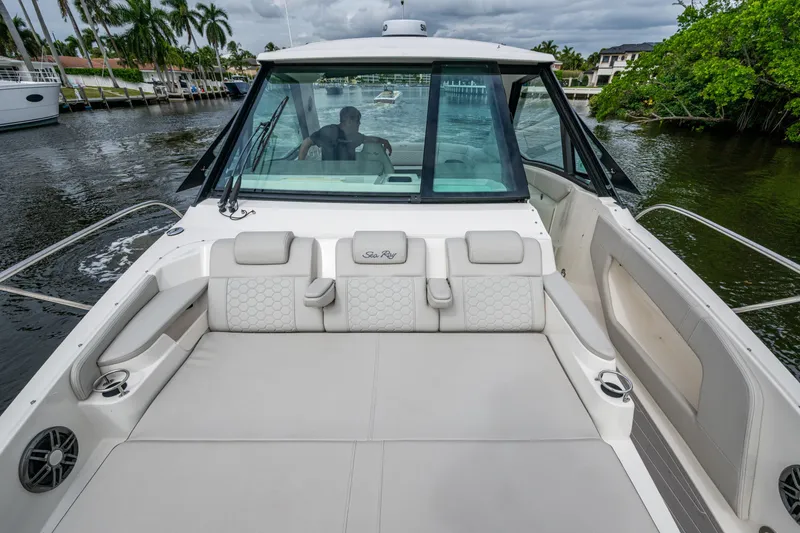 Slide: The Image of 2023 Sea Ray Sundancer 320 Outboard boat with spacious seating on a calm waterway. - 34