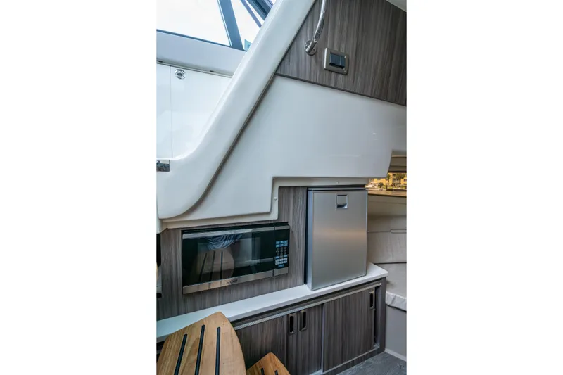 Slide: The Image of 2023 Sea Ray Sundancer 320 Outboard interior with microwave and compact fridge. - 39