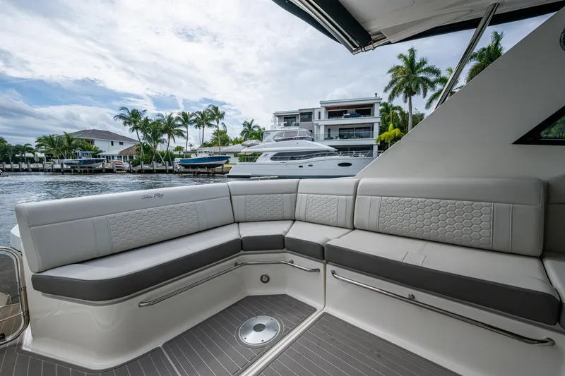 Slide: The Image of Luxurious seating on 2023 Sea Ray Sundancer 320 Outboard, docked near waterfront homes. - 43