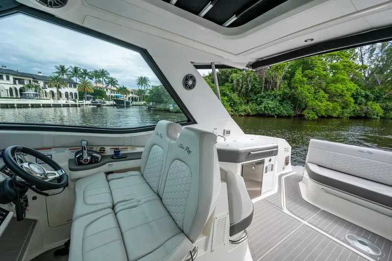 Slide: The Image of 2023 Sea Ray Sundancer 320 Outboard interior with luxurious seating and scenic waterway view. - 50
