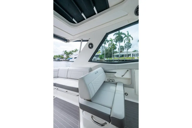 Slide: The Image of 2023 Sea Ray Sundancer 320 Outboard interior with sleek seating and waterfront view. - 51