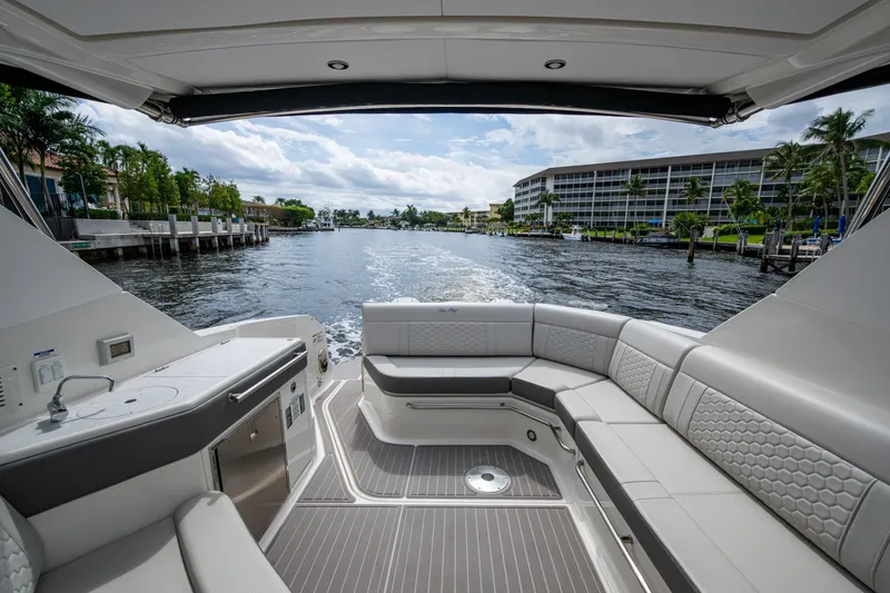 Slide: The Image of 2023 Sea Ray Sundancer 320 Outboard interior with waterfront view, featuring luxurious seating and amenities. - 56