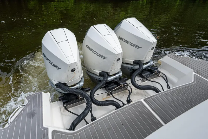 Slide: The Image of 2023 Sea Ray Sundancer 320 Outboard with triple Mercury engines on water. - 58