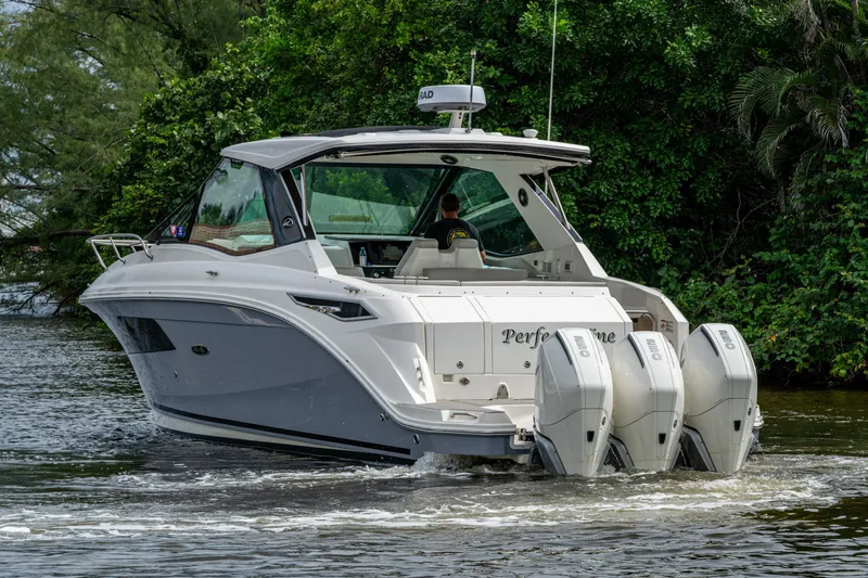 Slide: The Image of 2023 Sea Ray Sundancer 320 Outboard cruising on a scenic waterway. - 64