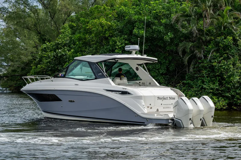 Slide: The Image of 2023 Sea Ray Sundancer 320 Outboard cruising on a scenic waterway. - 65