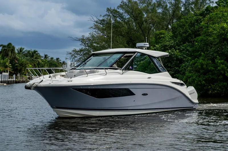 Slide: The Image of 2023 Sea Ray Sundancer 320 Outboard cruising on a scenic waterway. - 70