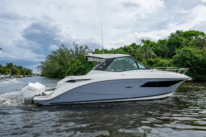 Slide: The Image of 2023 Sea Ray Sundancer 320 Outboard cruising on a scenic waterway. - 75