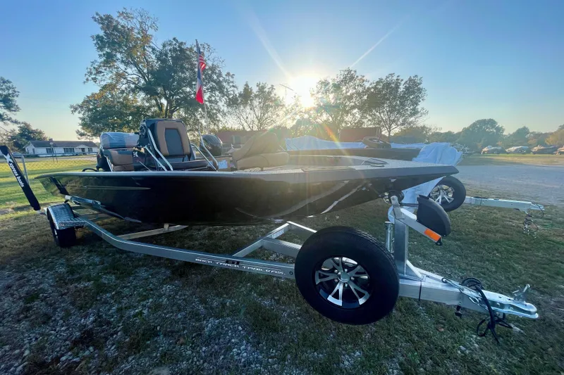 The Image of 2026 Xpress H20B Bay boat on trailer, parked outdoors at sunrise. - 0