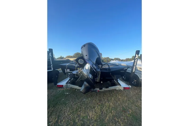 Slide: The Image of 2026 Xpress H20B Bay boat on trailer, rear view, outdoors. - 5